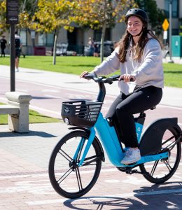 Female student on a Bird e-bike.